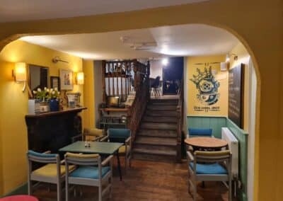 Inside The Kings Arms, a view of the seating area and stairs.
